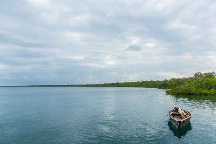 peaceful scene with a boat and the cloudy sky in kilwa in southern tanzania